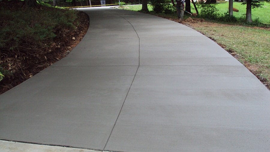 Full completed concrete driveway beside park